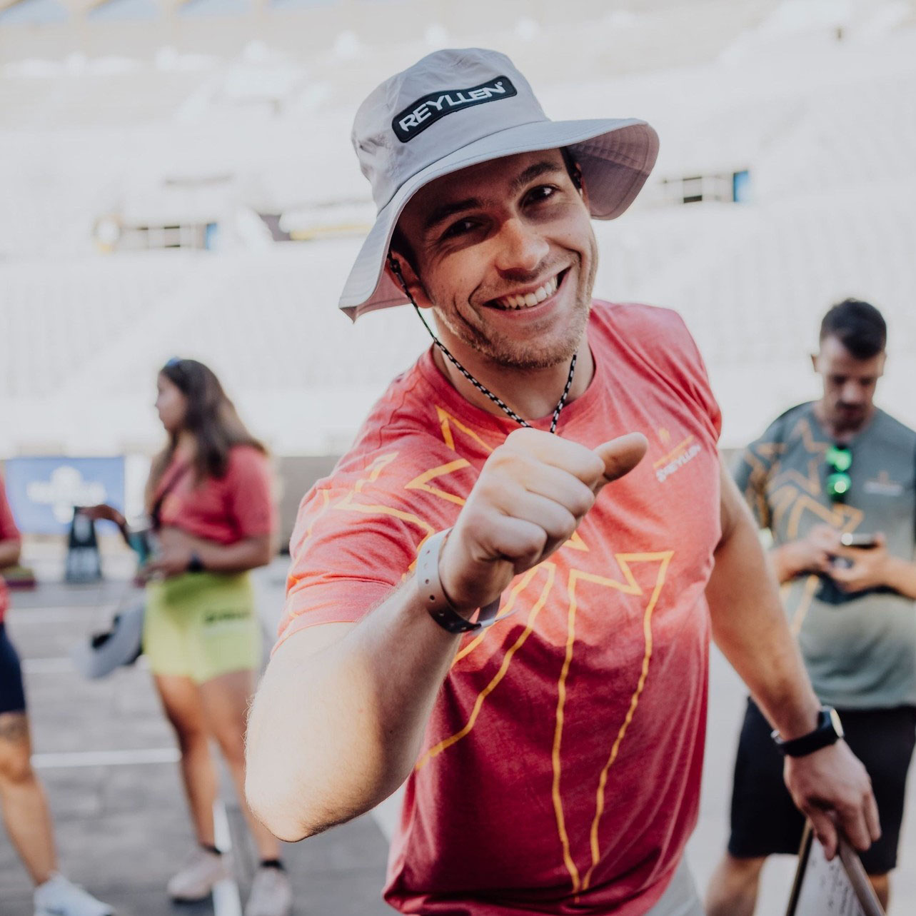 Coach Gab smiling into the camera giving a fist bump to congratulate you on your workout efforts!
