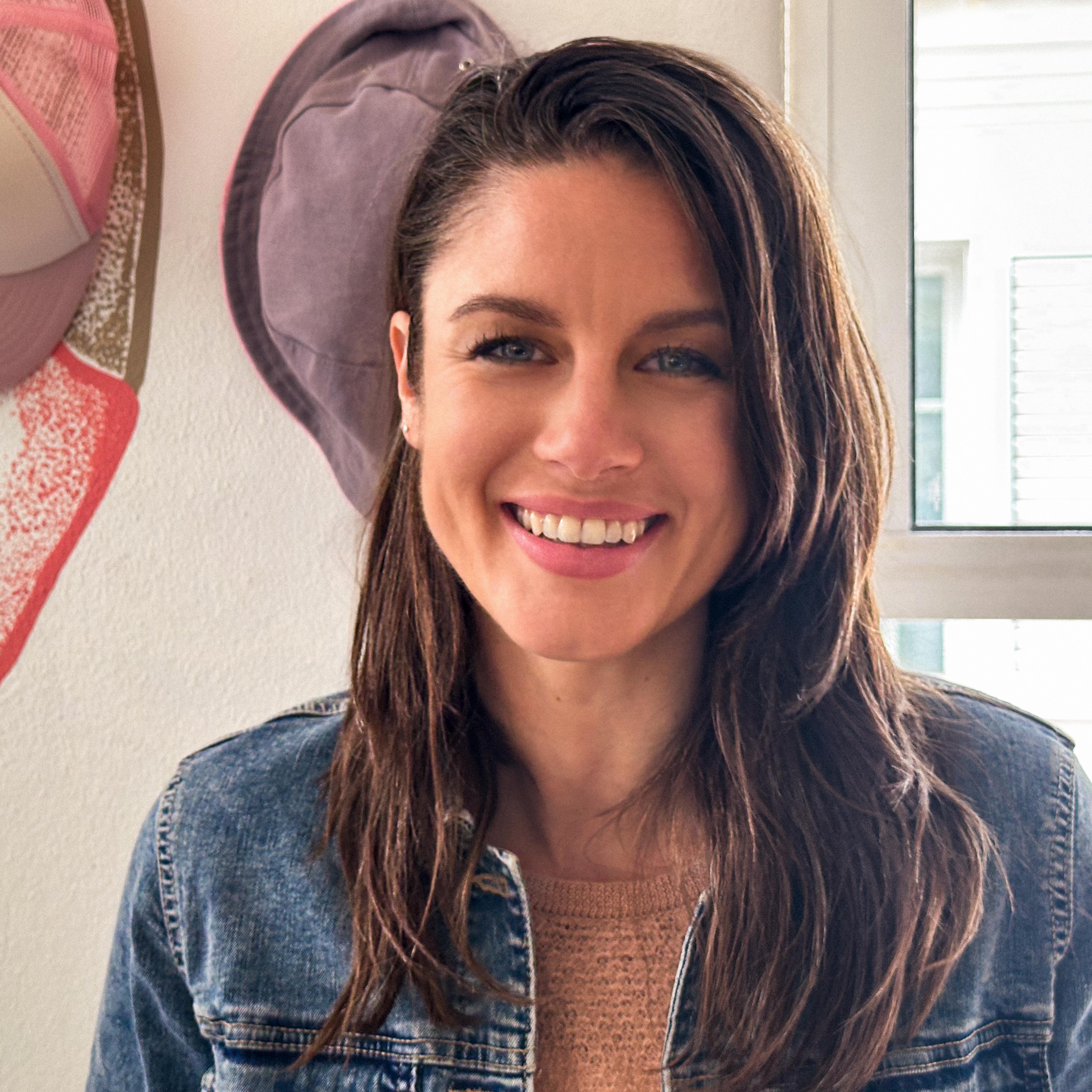 Klara Bright smiling all teeth into the camera showing her warm and caring energy